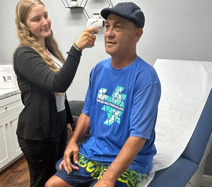 Care team member checking a patient's temperature