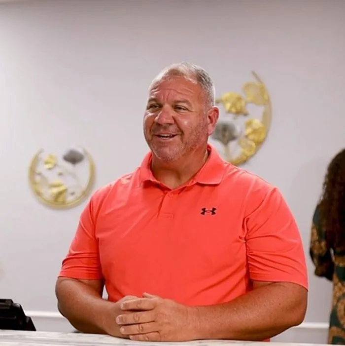 Patient smiling at the front desk of Internal Medicine MD